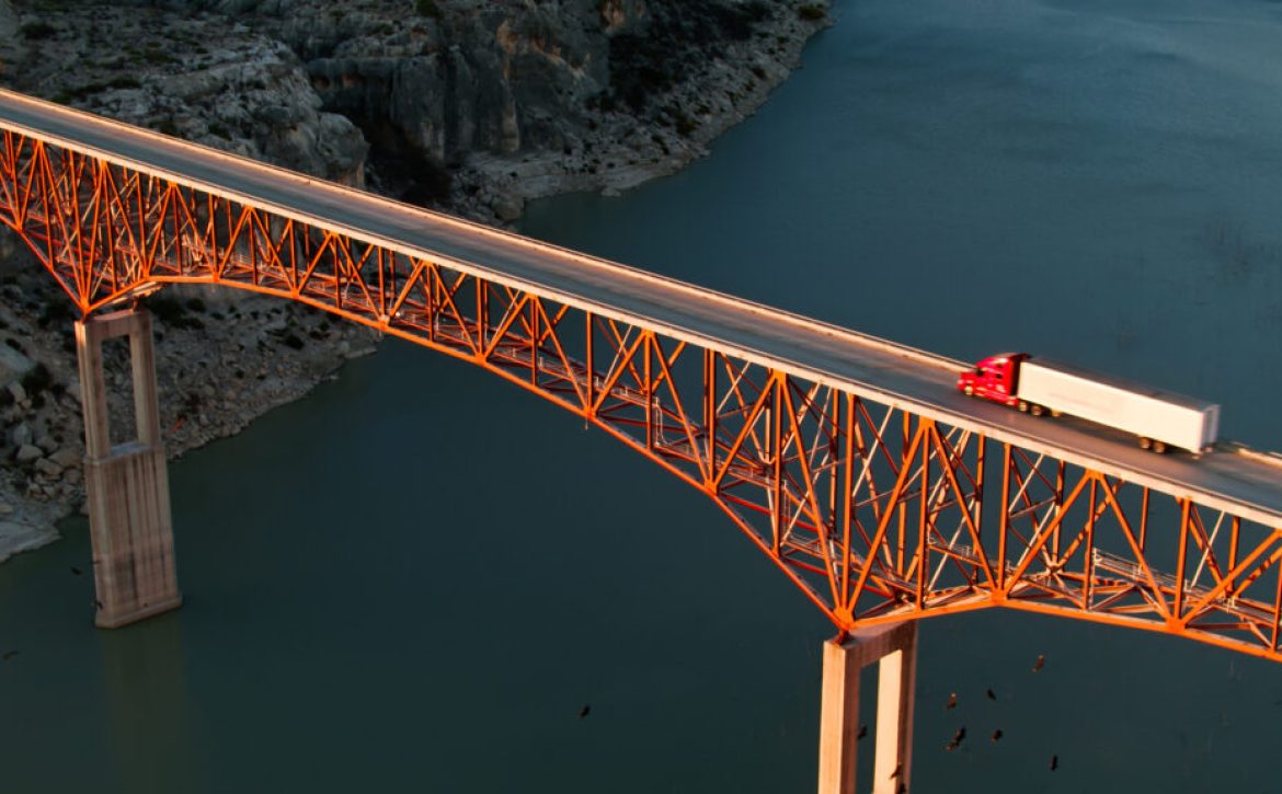 High Angle Aerial Shot of Truck Driving Over Pecos River Bridge