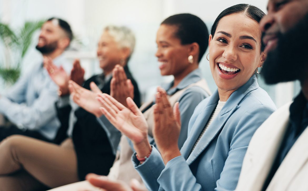 Business people, woman and team applause in conference, tradeshow and support feedback of success. Happy employees, audience and clapping in celebration, praise or winning award at seminar convention