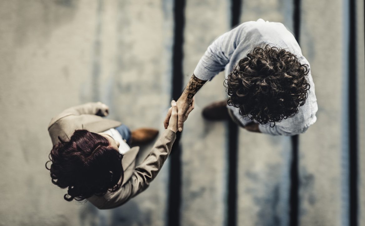 Male Manager Shaking Hands With Female Applicant