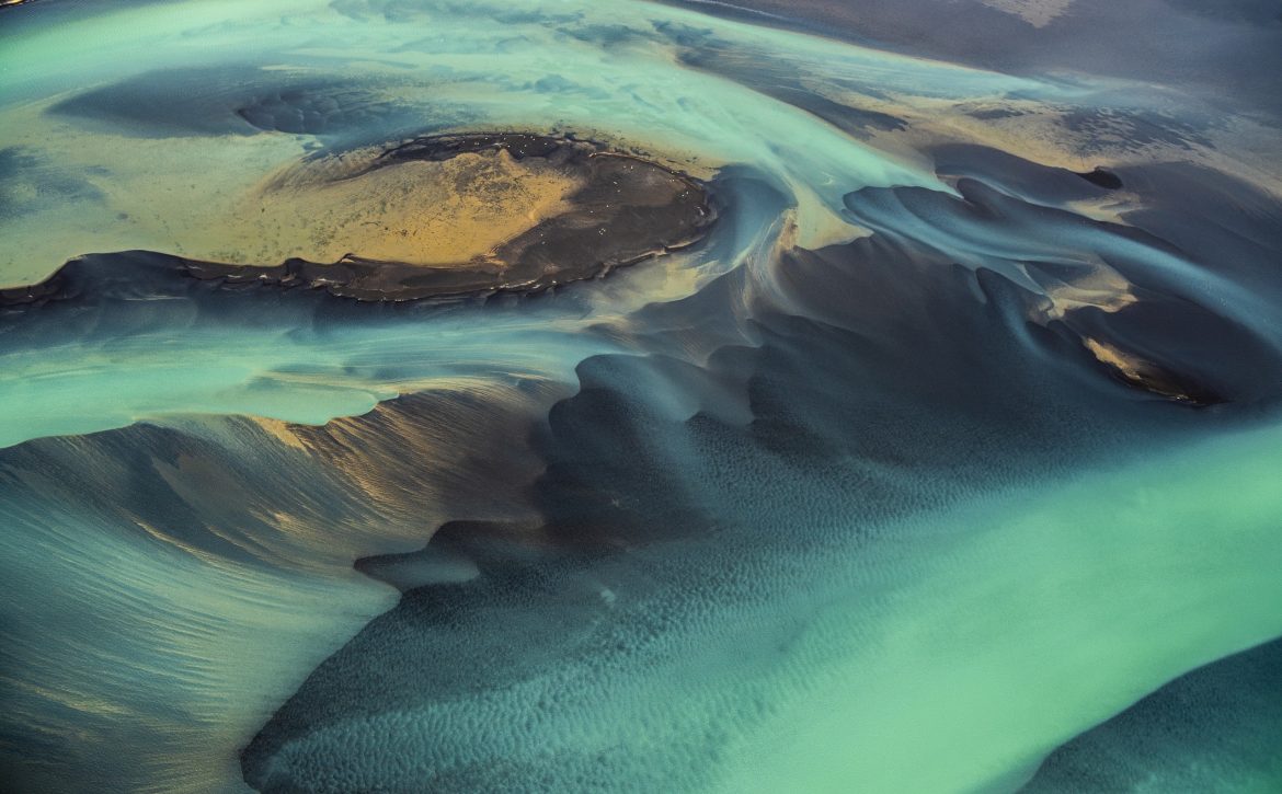 Beautiful emerald-colored glacial rivers of Iceland, taken from a helicopter
